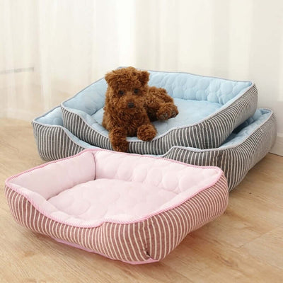 Cozy dog and cat kennels in various sizes with a plush toy resting on top, showcasing cool summer fabric.