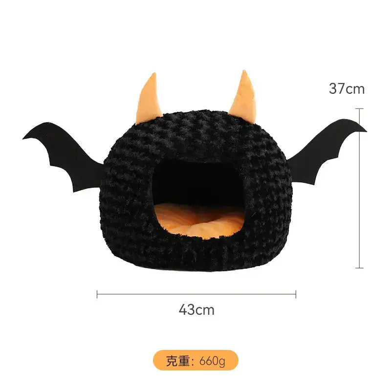 Halloween-themed pet house with bat wings and horns, perfect for keeping cats and dogs cozy during fall and winter.