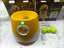 Automatic dog tennis ball launcher with yellow design, includes tennis balls, packaging, and quick start guide.