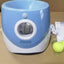 Automatic dog tennis ball launcher with tennis balls for outdoor pet play and exercise.