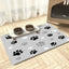 Splash-proof pet feeding mat with paw prints design, featuring non-slip surface and diatom mud absorbency to keep floors clean.