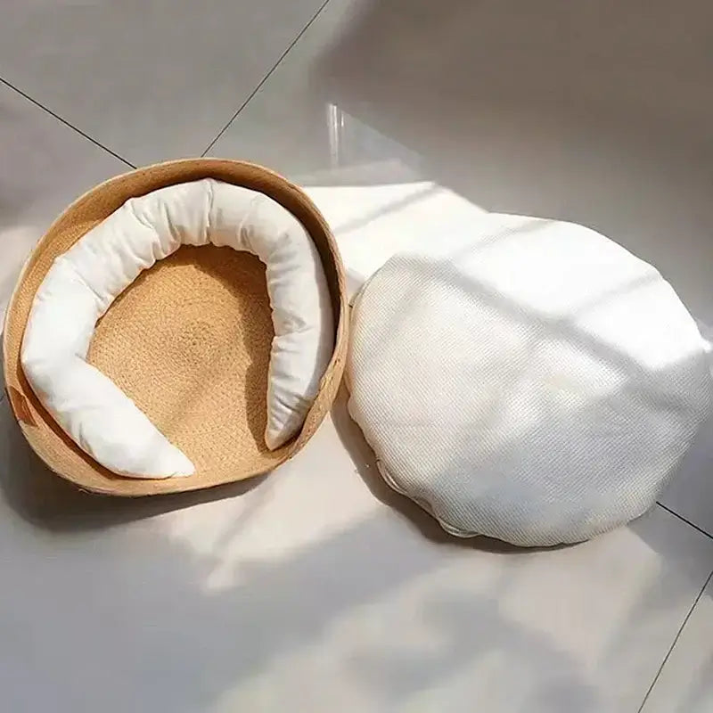 Handmade bamboo pet bed with removable white cushion.