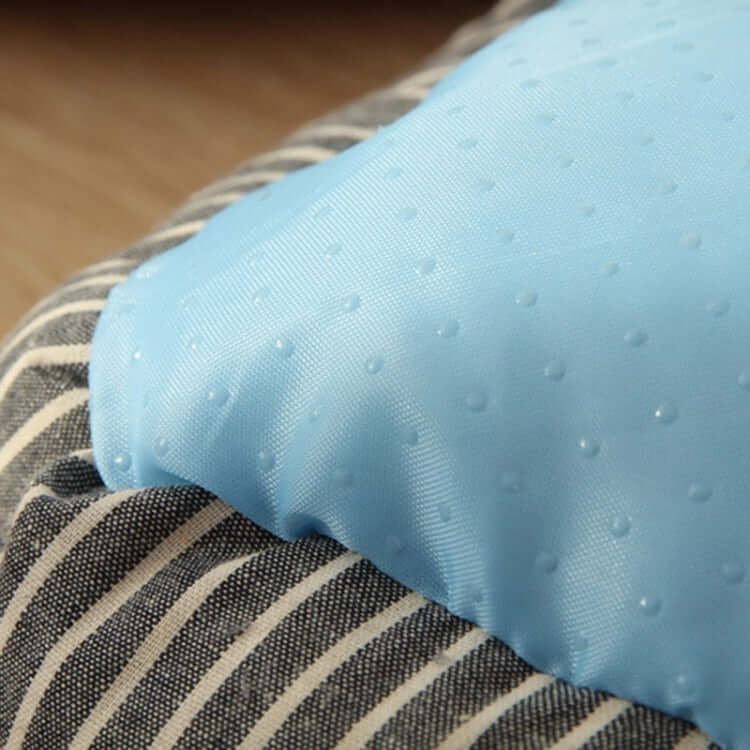 Close-up of the cool, ice silk fabric used in a summer dog or cat kennel, featuring dotted texture and striped cotton base.