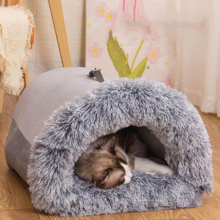 Cozy pet house bed with plush interior; cat relaxing in semi-enclosed design, perfect for warmth and security.