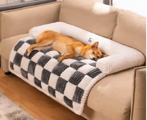 Plush dog mat in checkered design on a sofa, providing cozy comfort for a resting pet.